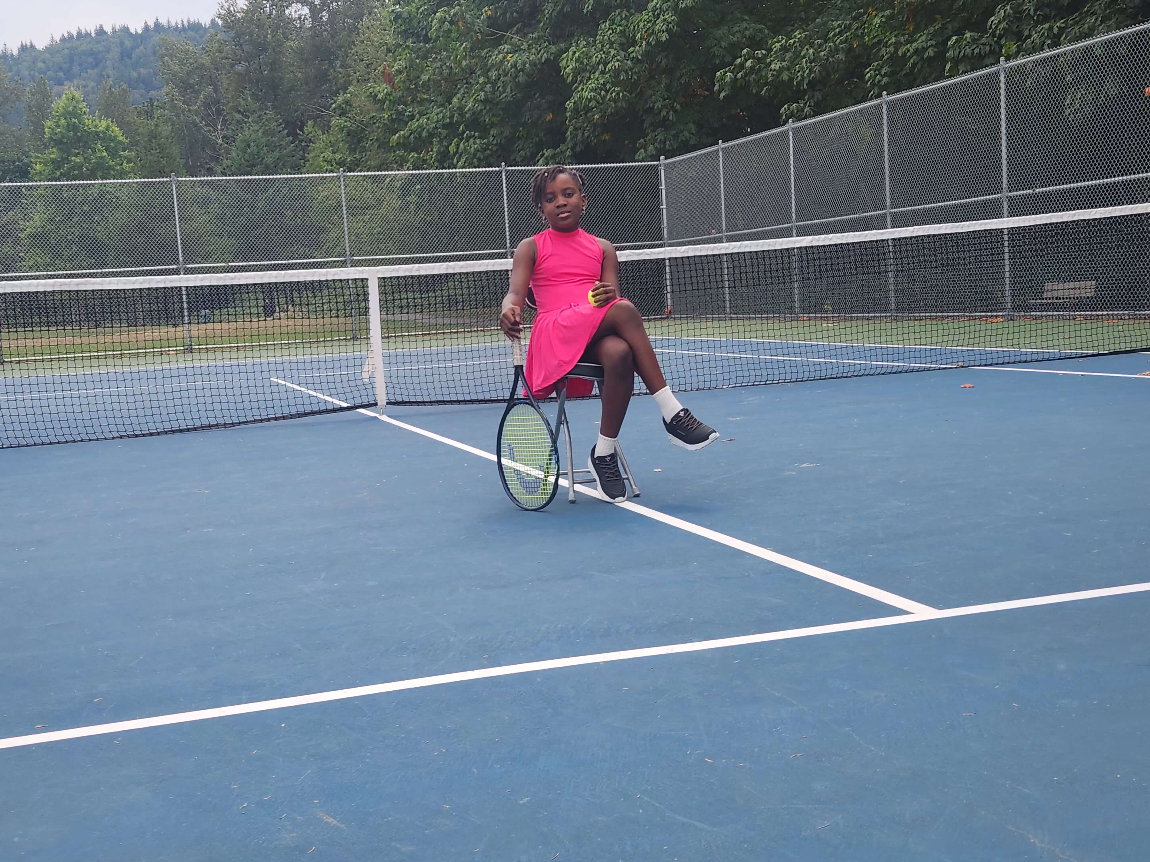 Jemima Adumeta on a tennis court in a pink dress